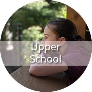 The text "Upper School" is displayed in front of an image of a girl in a short sleeve burgundy polo shirt is resting her chin on her folded arms. She is outside and gazes off into the distance.