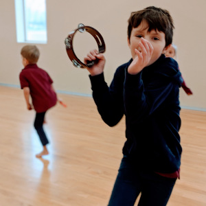 Boy playing the tambourine.