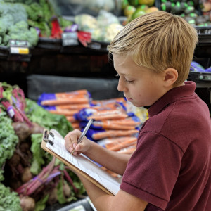 Elementary student taking notes on a field trip