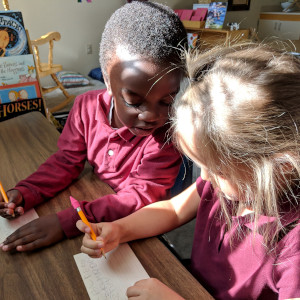 Two preschool students sitting next to each other