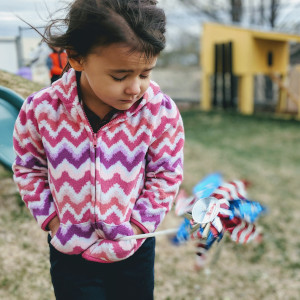 Child looking at a pinwheel