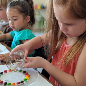 Preschool children performing a science experiment